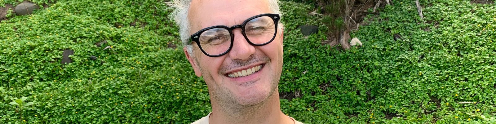 a man smiling with glasses