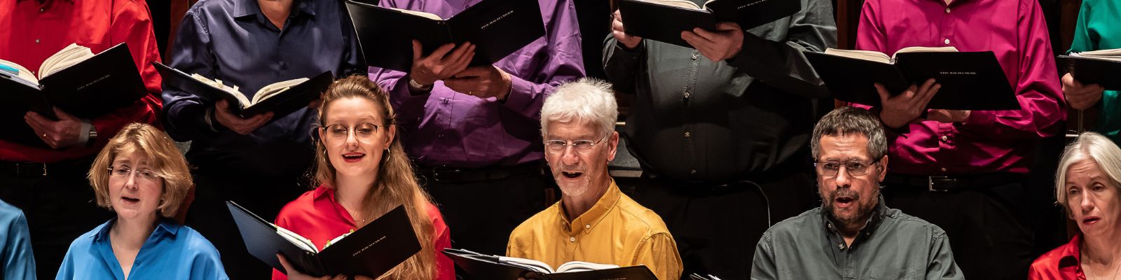 a group of people singing in a choir