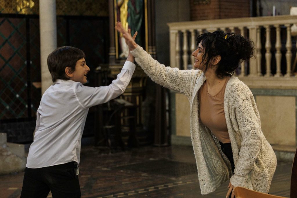 A woman and a boy dancing in the church