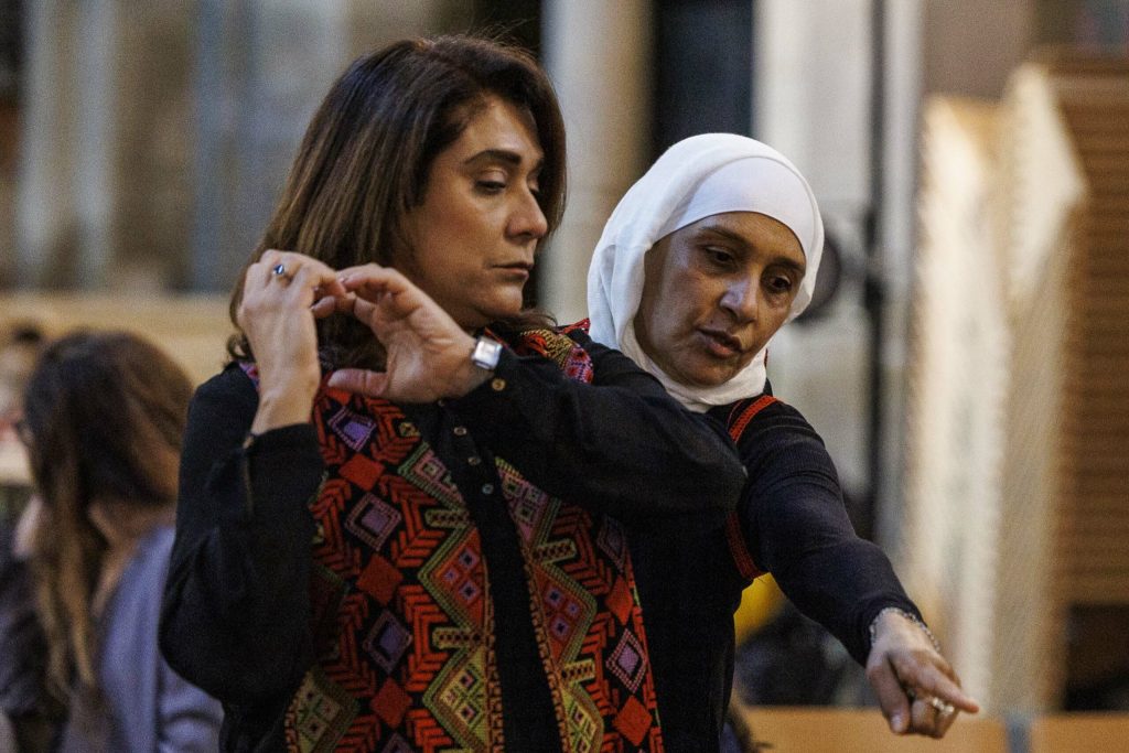 a woman holding a woman's arm