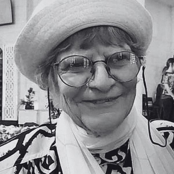 a woman wearing glasses and a hat