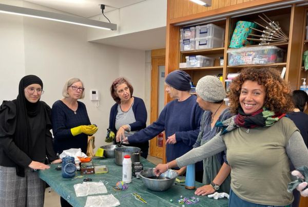 a group of women standing around a table